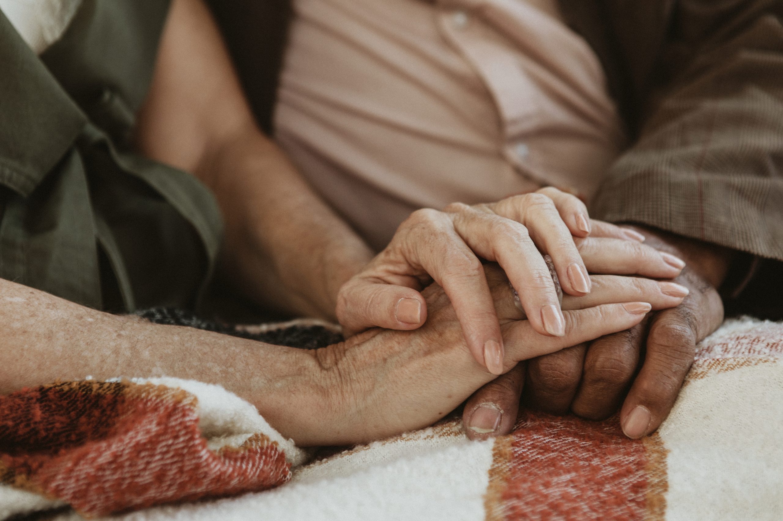 Senior couple holding hands together