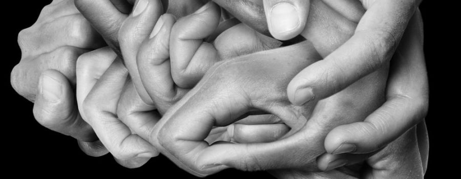 black and white images of hands together forming outline of brain