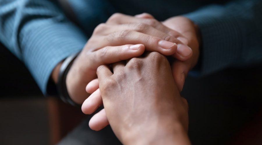 couple holding hands intimately