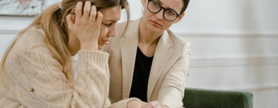woman being comforted by therapist
