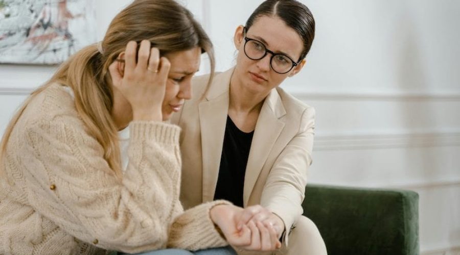 woman being comforted by therapist