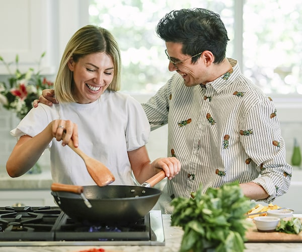 couple cooking together and smiling