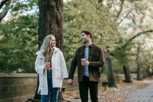 couple holding hands walking and talking