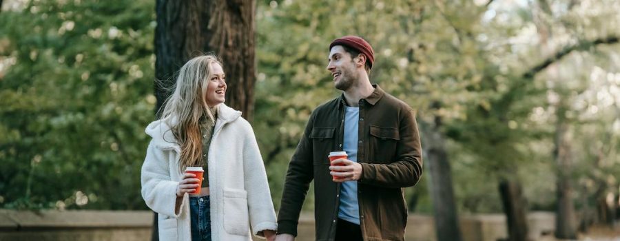 couple holding hands walking and talking