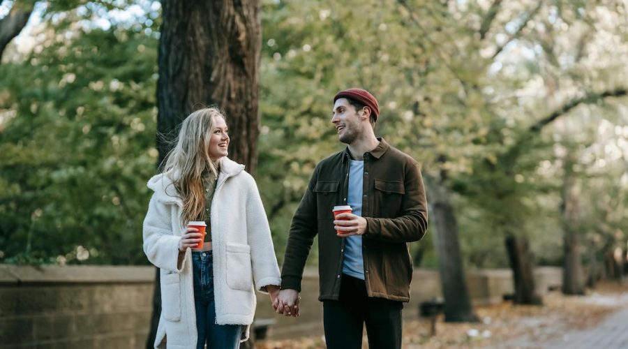 couple holding hands walking and talking